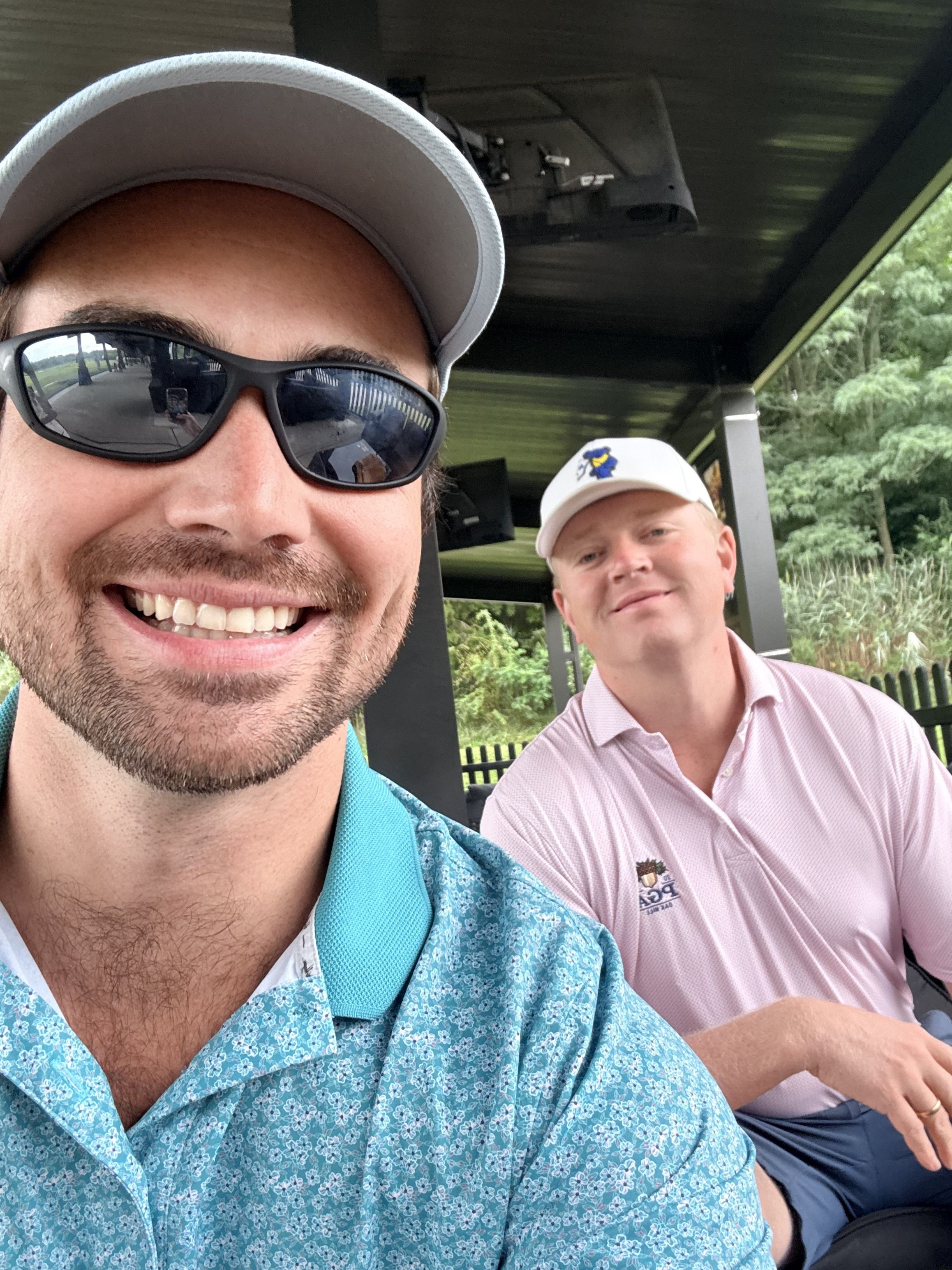 Golf course selfie under a hitting-bay roof, Long Island